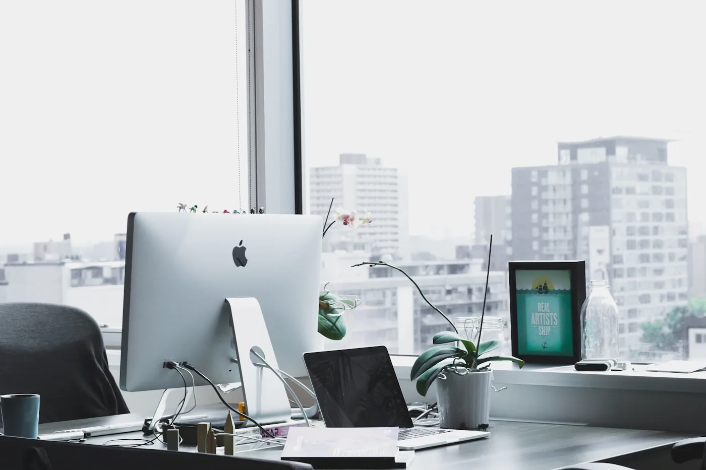 Workstation by a window with city view — office workstation design Pune